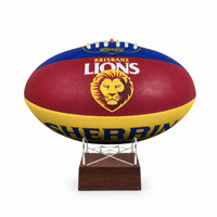 A Brisbane Lions AFL ball displayed on a clear stand with a dark wood base, set against a plain white background.