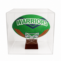 A green and navy blue Warriors rugby ball mounted on a clear acrylic display case with a small wooden base.