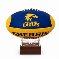 A West Coast Eagles AFL ball urn displayed on a clear acrylic stand with a dark wood base, set against a plain white background.