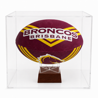 A maroon and gold Brisbane Broncos rugby ball mounted on a clear acrylic display case with a wooden base, shown against a white background.