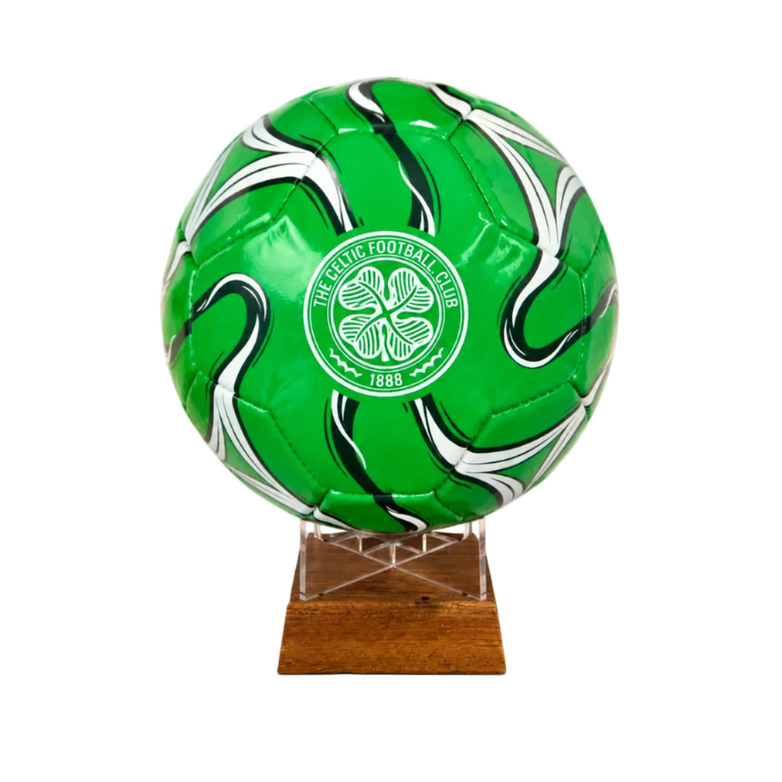 A green soccer ball with white and black swirl patterns and a white Celtic Football Club crest, displayed on a clear acrylic stand with a wooden base against a white background.