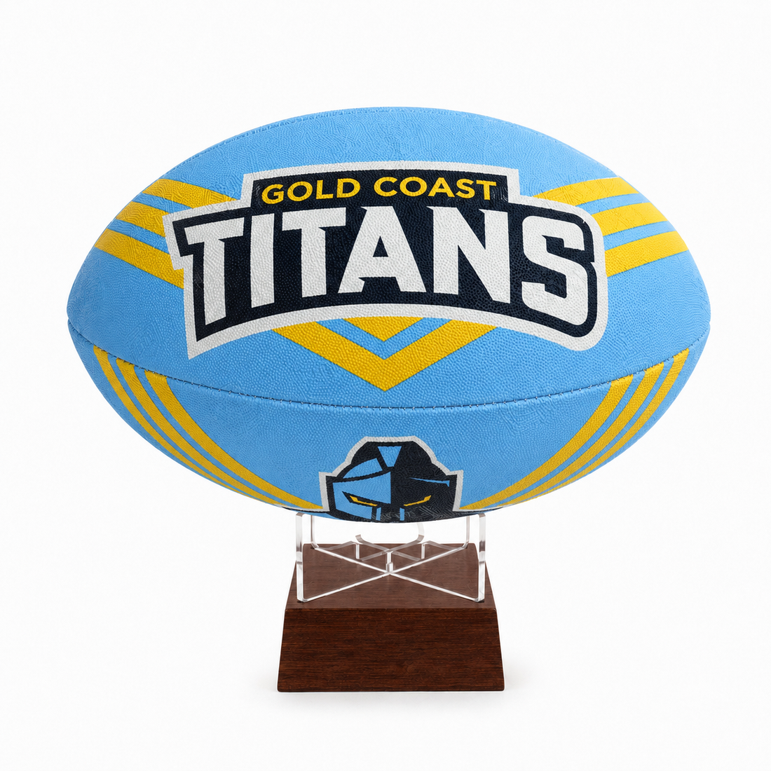 A light blue Gold Coast Titans rugby ball displayed on a clear acrylic stand with a dark brown wooden base, set against a plain white background.