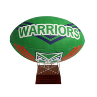 Green rugby league ball with 'Warriors' text on a white background
