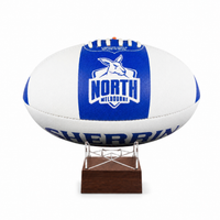 A cremation urn designed and made from an Australian football, with a blue and white North Melbourne Kangaroos theme, mounted on a wooden stand.