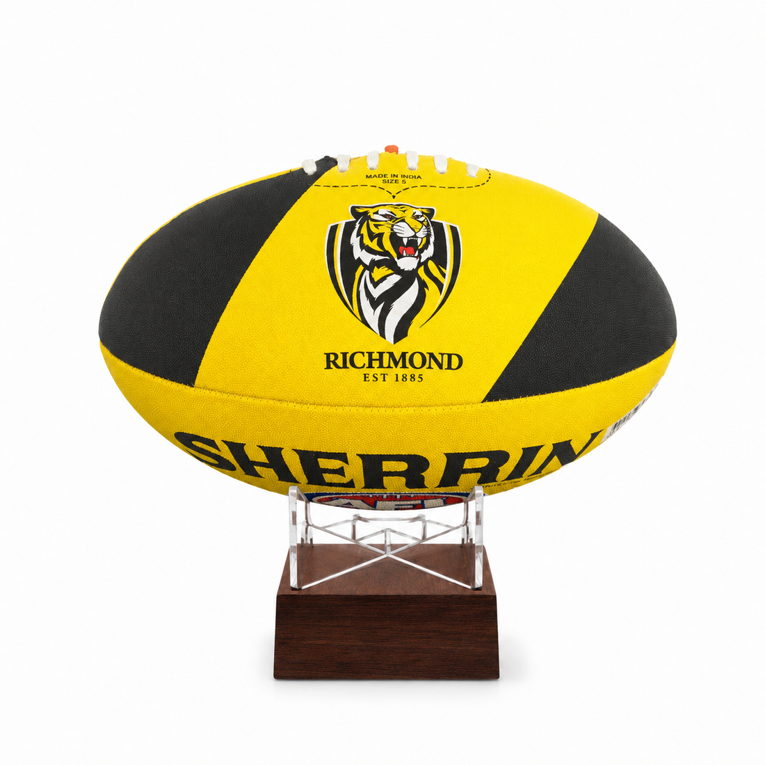 A yellow and black Richmond Tigers rugby ball displayed on a clear acrylic stand with a dark brown wooden base against a white background.