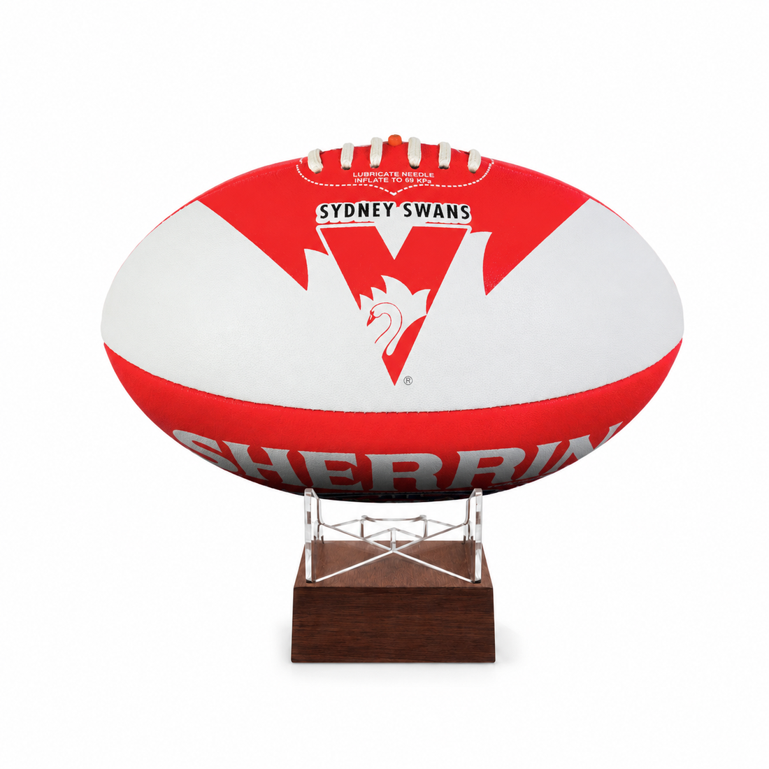 A red and white Sydney Swans AFL ball urn displayed on a clear acrylic stand with a dark brown wooden base, set against a plain white background.