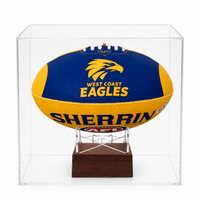 A West Coast Eagles AFL ball urn displayed inside a clear acrylic display case on a wooden stand, photographed against a clean white background.